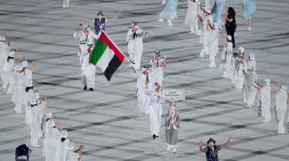 Emirati Swimmer Bears The UAE Flag At The Olympics